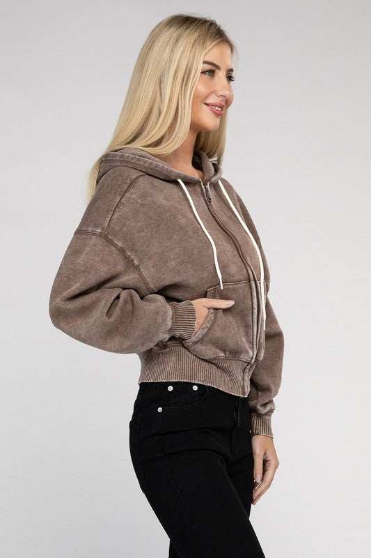 Acid Wash Fleece Cropped Zip-Up Hoodie with pockets on model, featuring drawstring hood and relaxed fit.
