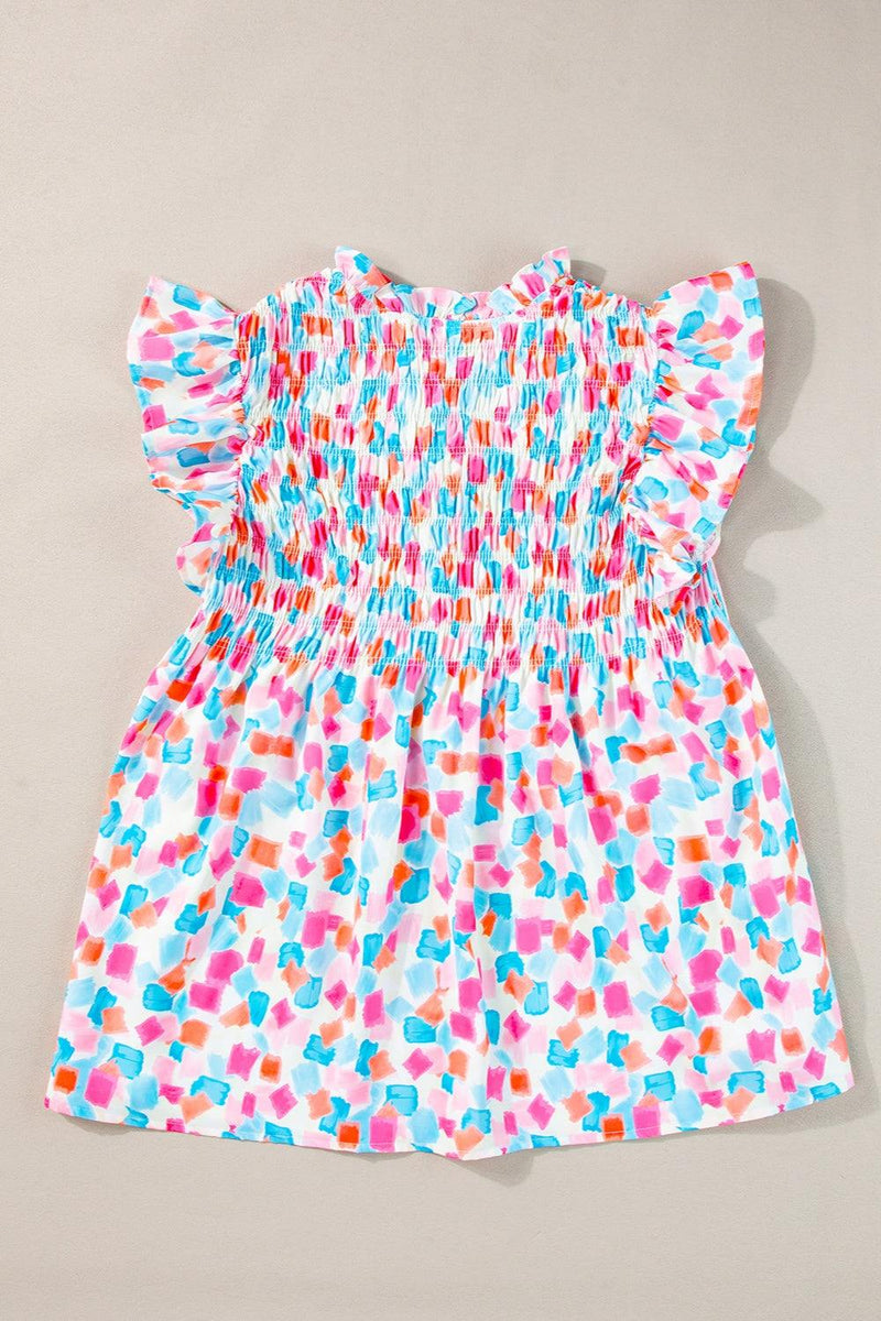 Ruffled printed notched cap sleeve blouse in colorful pattern.