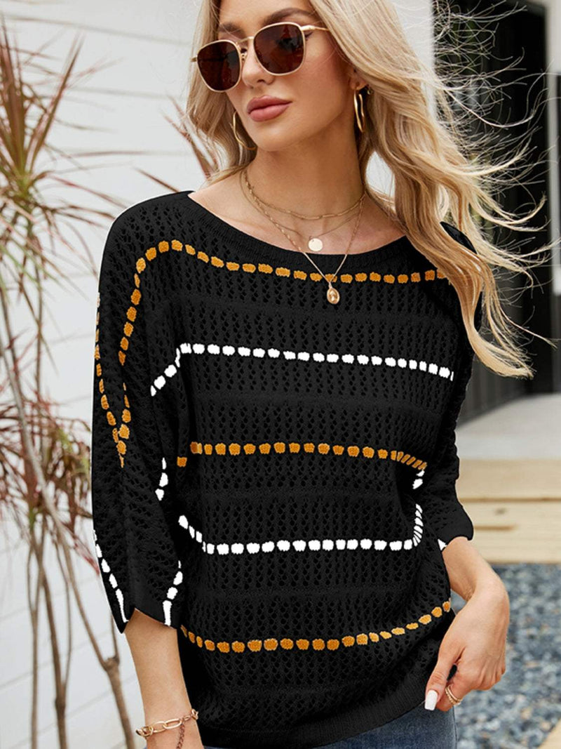 Eyelet Striped Round Neck Knit Top in black with multicolor stripes, worn by woman outdoors.