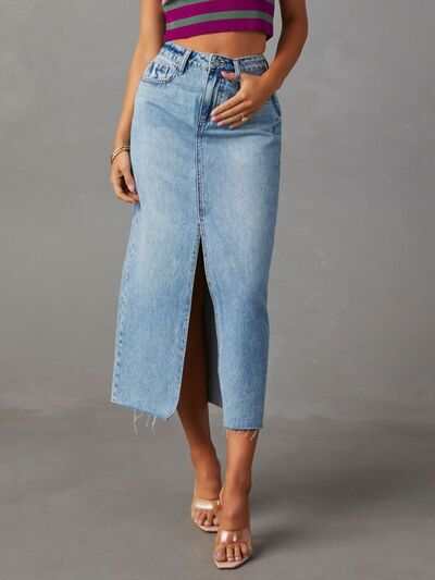 Raw hem front slit denim midi skirt with button, pockets, and slight stretch.