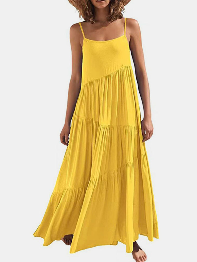 Full Size Ruched Tiered Spaghetti Strap Dress in bright yellow, featuring moderate stretch and a flowing design.