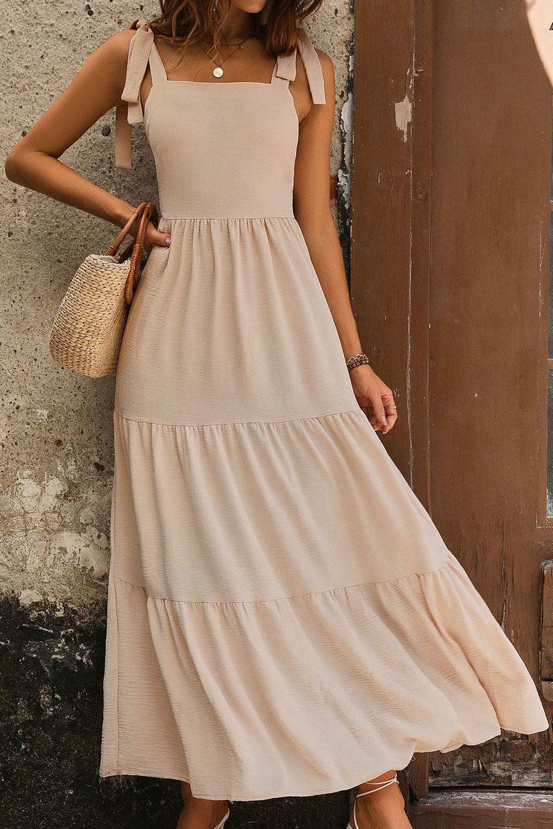 Perfee Tie Shoulder Smocked Tiered Dress in beige, sleeveless with smocked bodice and tie shoulders.