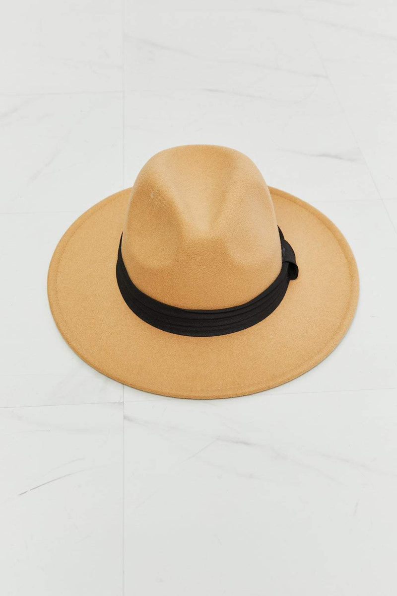 Dark tan Fedora hat with black ribbon, adjustable straps, 3.5-inch brim, made of 100% polyester.