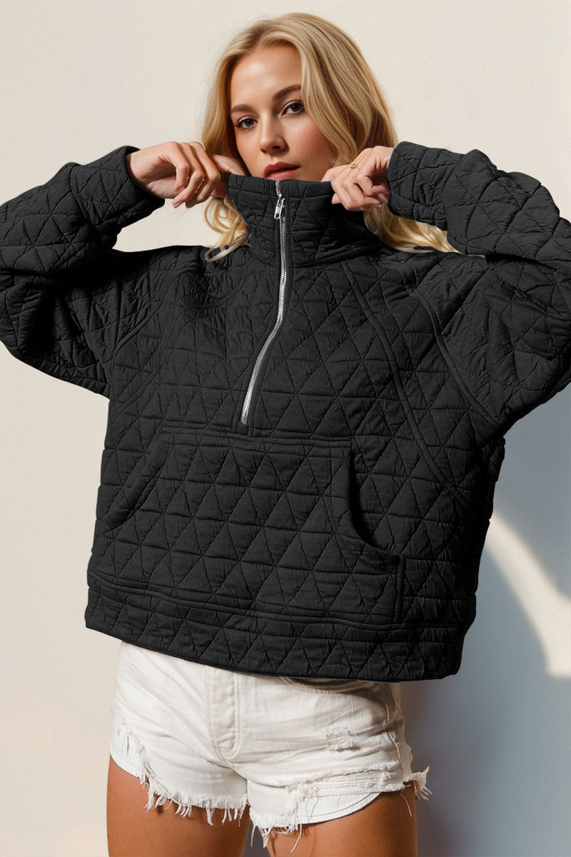 Black quilted half zip long sleeve sweatshirt with pocket.