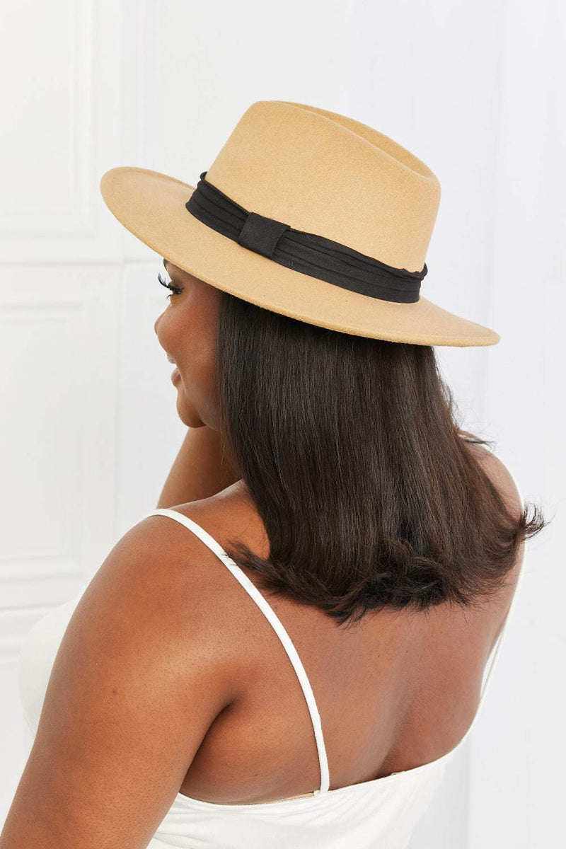 Dark tan fedora hat with black ribbon detail, perfect for outdoor and formal occasions.