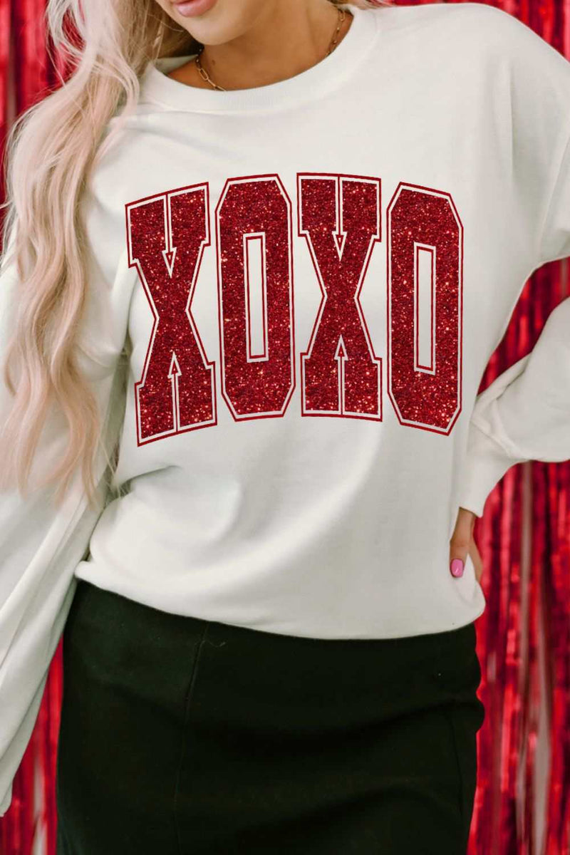 Valentine’s Day XOXO glitter round neck sweatshirt with red letters.