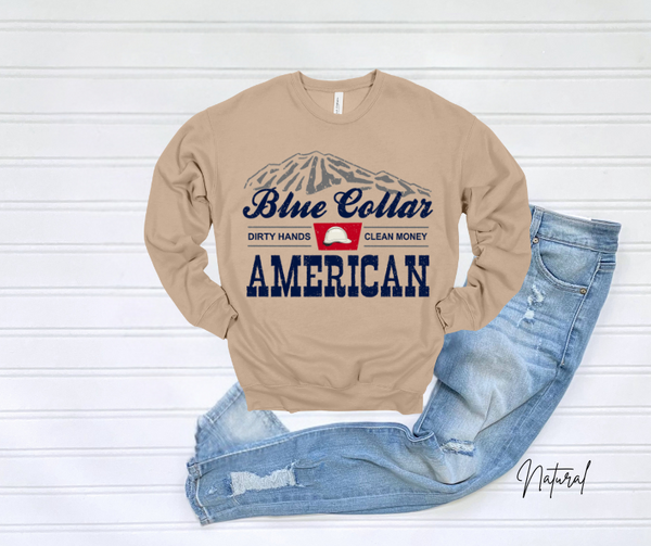 Blue Collar Sweatshirt with graphic design and jeans on light background.