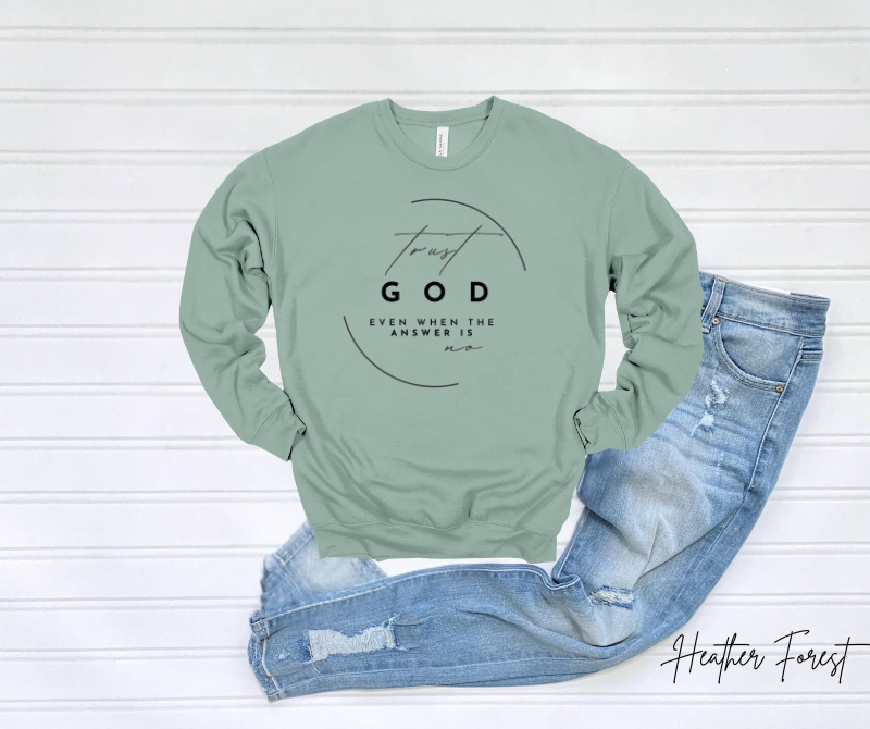 Light green Trust God Sweatshirt with motivational text, styled with blue jeans.