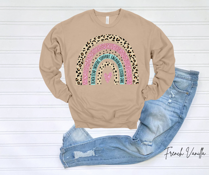 Teacher Rainbow Sweatshirt with colorful and leopard print design displayed on wooden background.
