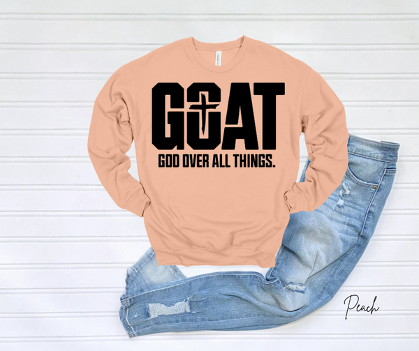 GOAT Sweatshirt with "God Over All Things" text in bold on a light peach color.