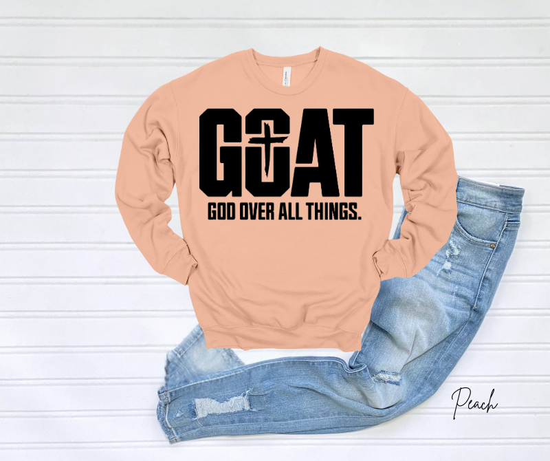 GOAT Sweatshirt with "God Over All Things" text in bold on a light peach color.