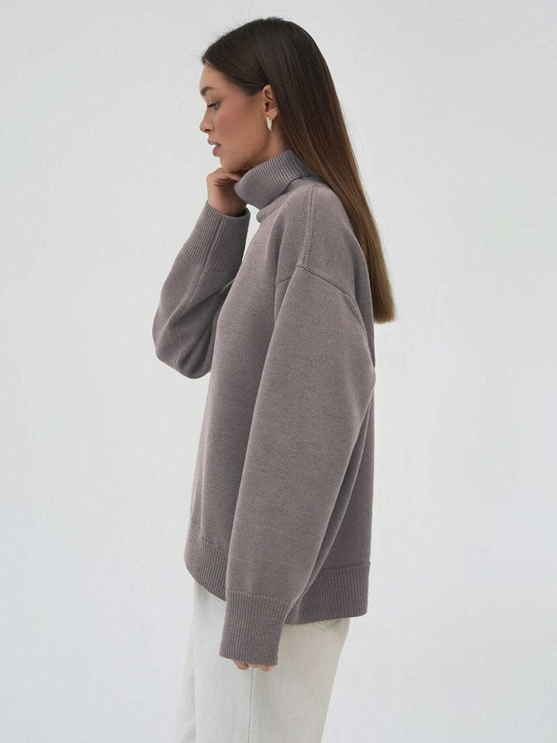 Turtleneck long sleeve sweater in gray with slightly stretchy fabric.