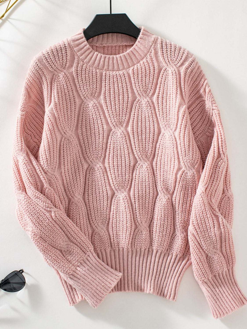 Round neck dropped shoulder sweater in pink with a cable knit design.