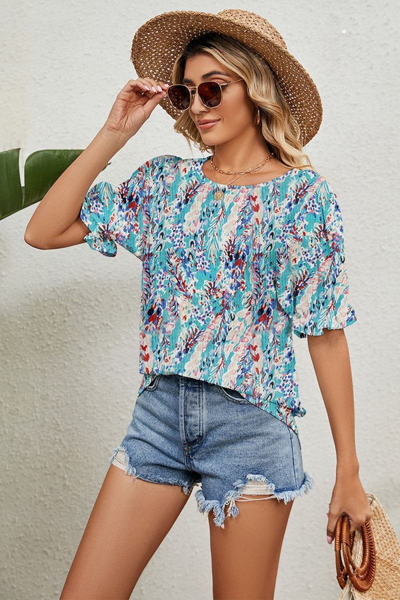 Round neck flounce sleeve blouse with floral print paired with denim shorts and straw hat.