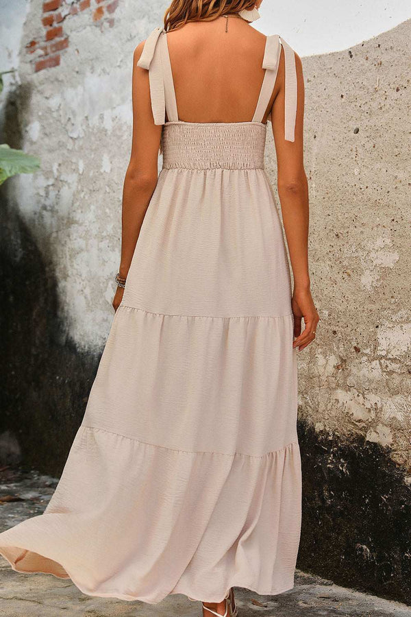 Perfee Tie Shoulder Smocked Tiered Dress in beige, featuring a smocked design and tiered skirt.