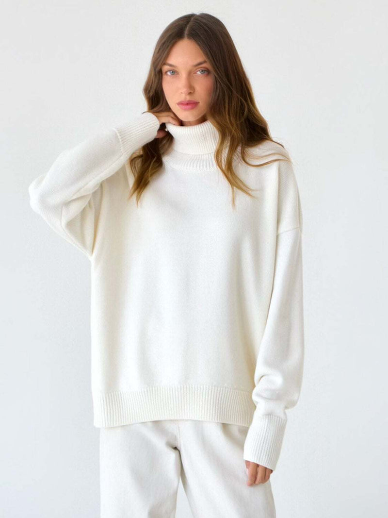 Turtleneck long sleeve sweater in white, slightly stretchy, made of viscose, polyester, and nylon.