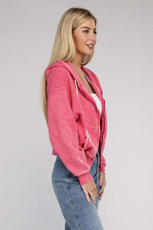 Blonde woman modeling pink acid wash fleece cropped zip-up hoodie with drawstring hood and pockets.