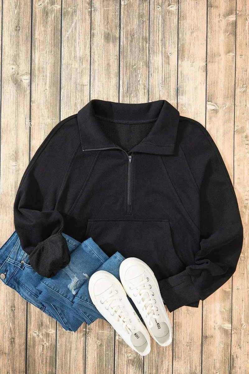 Half Zip Long Sleeve Sweatshirt in black with jeans and white sneakers on wood floor.