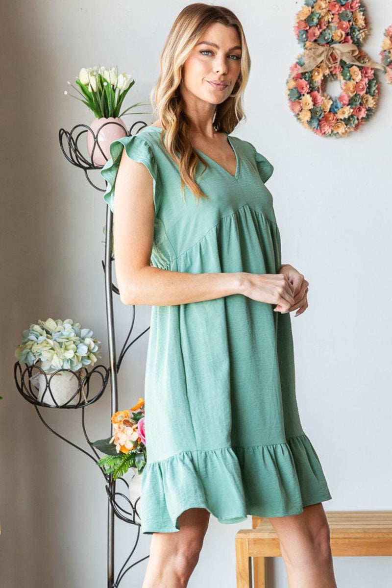 Heimish Full Size Short Sleeve V Neck Ruffled Hem Dress in green, featuring a feminine silhouette and delicate ruffled details.