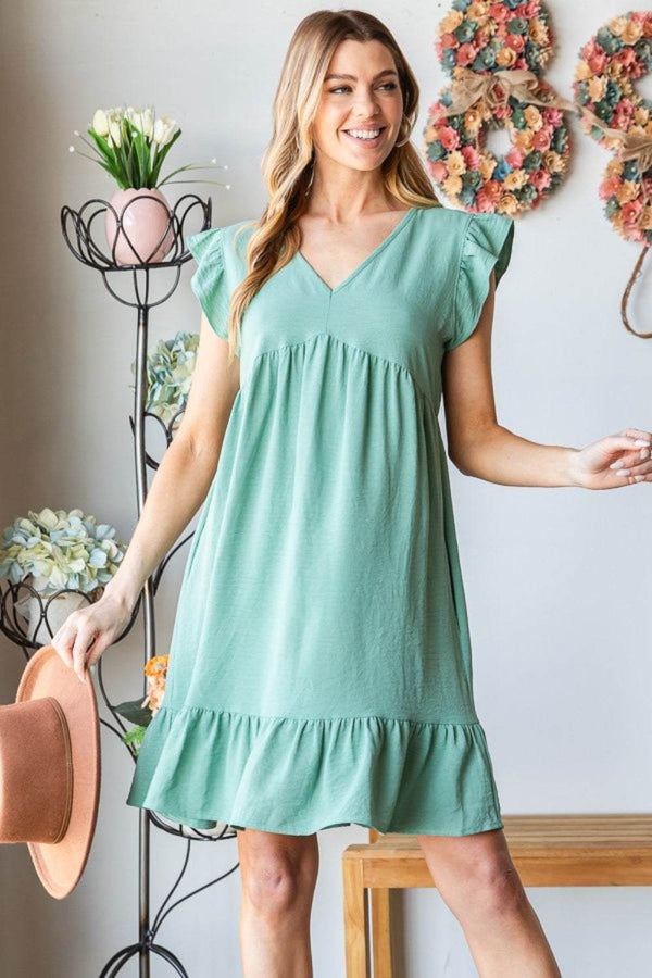 Heimish full size short sleeve V neck ruffled hem dress in green, featuring elegant ruffles and a flattering silhouette.