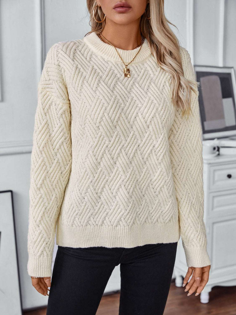 Round neck long sleeve woven sweater in cream, featuring a textured pattern and relaxed fit.