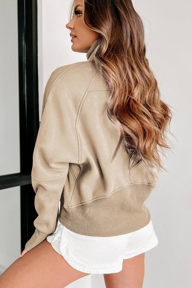 Fleece lined zip up stand collar thumbhole sleeve sweatshirt in beige.