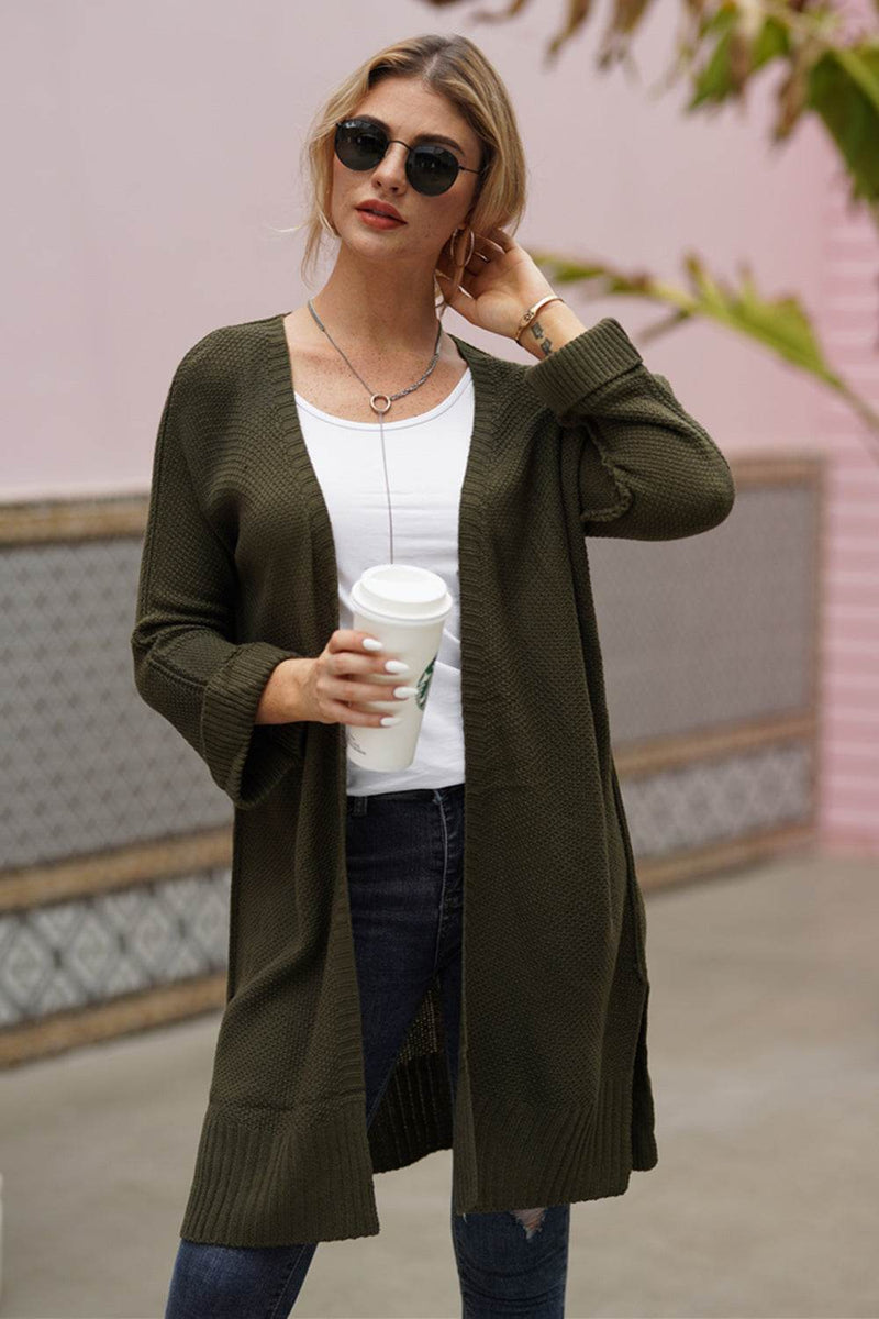 Open front long sleeve cardigan in olive green worn by a woman outdoors