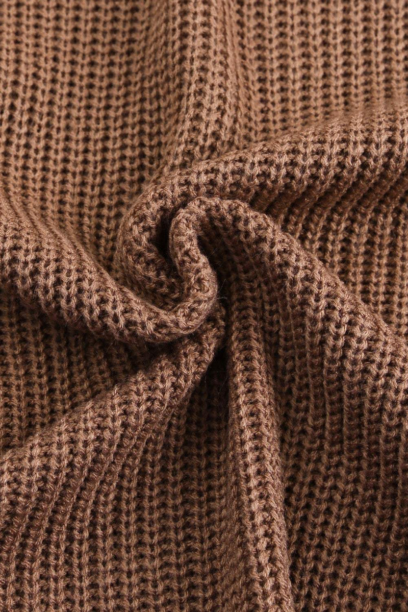 Close-up of brown openwork V-neck button-up cardigan fabric.
