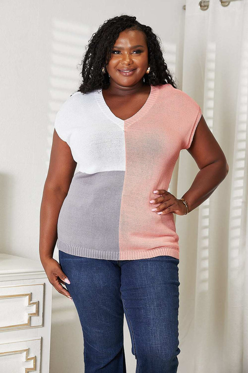 Color block V-neck knit top with short sleeves, ribbed texture, and modern design.