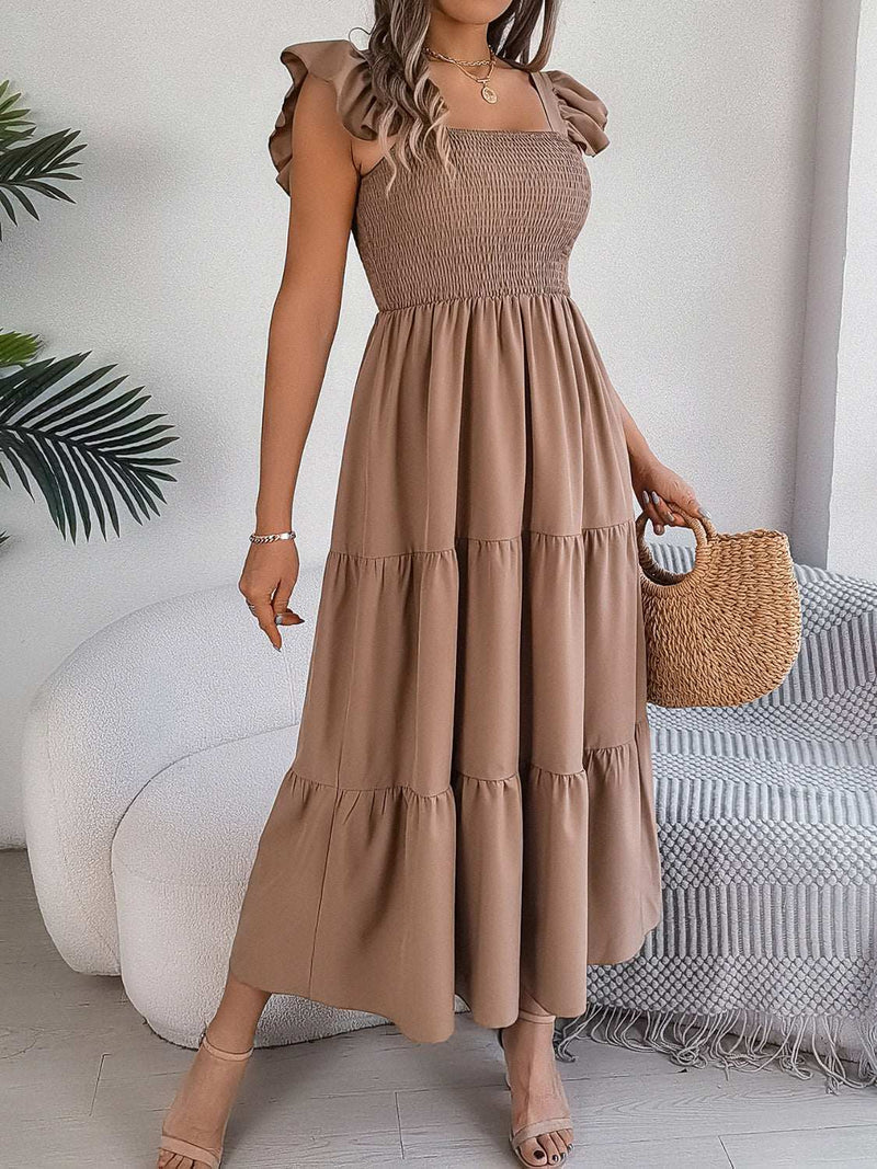 Smocked square neck cap sleeve midi dress in brown, polyester and elastane, features tiered design; styled with a woven handbag.
