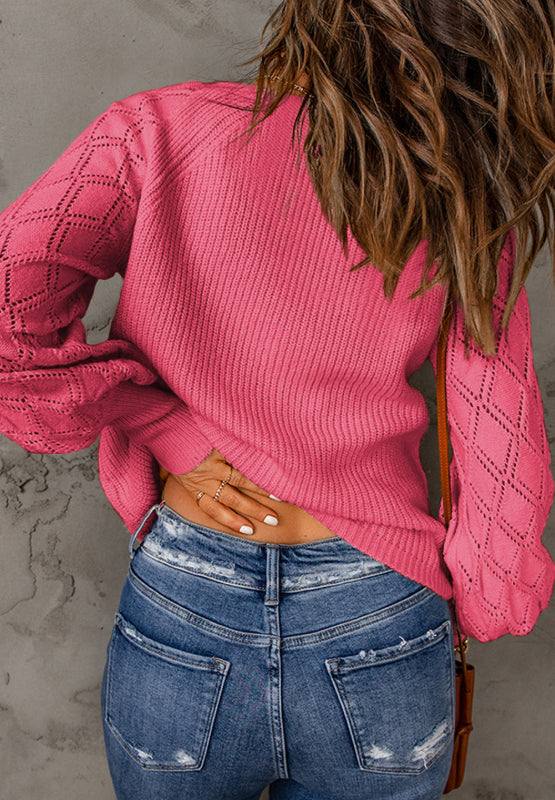 Pink openwork V-neck button-up cardigan with ribbed texture and slightly stretchy material.
