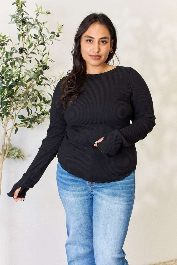 Culture Code Full Size Ribbed Round Neck Long Sleeve Top in black, worn by a model, features a crew neckline and elongated sleeves.