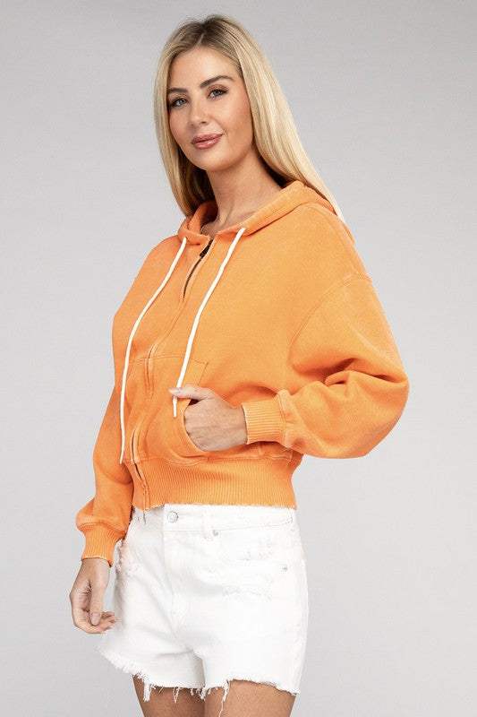 Acid Wash Fleece Cropped Zip-Up Hoodie in orange with drawstring hood and pockets worn by model.