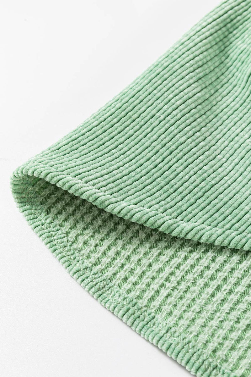 Mist green corduroy fabric close-up.