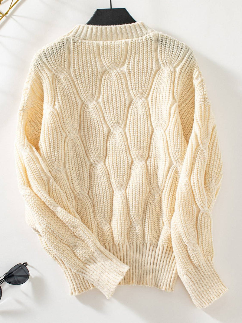 Round neck dropped shoulder sweater made of 100% polyester with textured knit design.