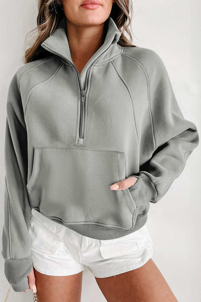 Fleece lined sweatshirt with zip up stand collar and thumbhole sleeves.