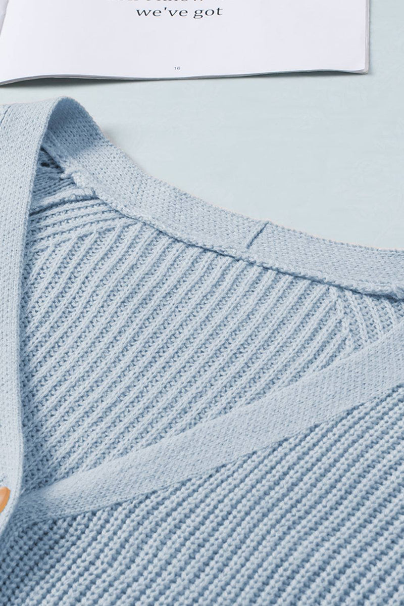 Light blue openwork V-neck button-up cardigan made from 100% acrylic material.