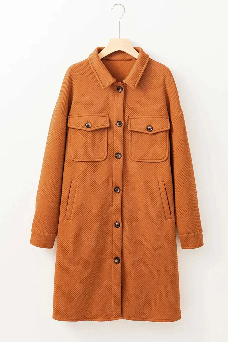 Textured button down collared neck coat hanging on a hanger.
