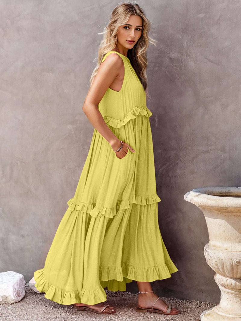 Ruffled sleeveless tiered maxi dress with pockets in yellow, high-low hem, and smocked design.