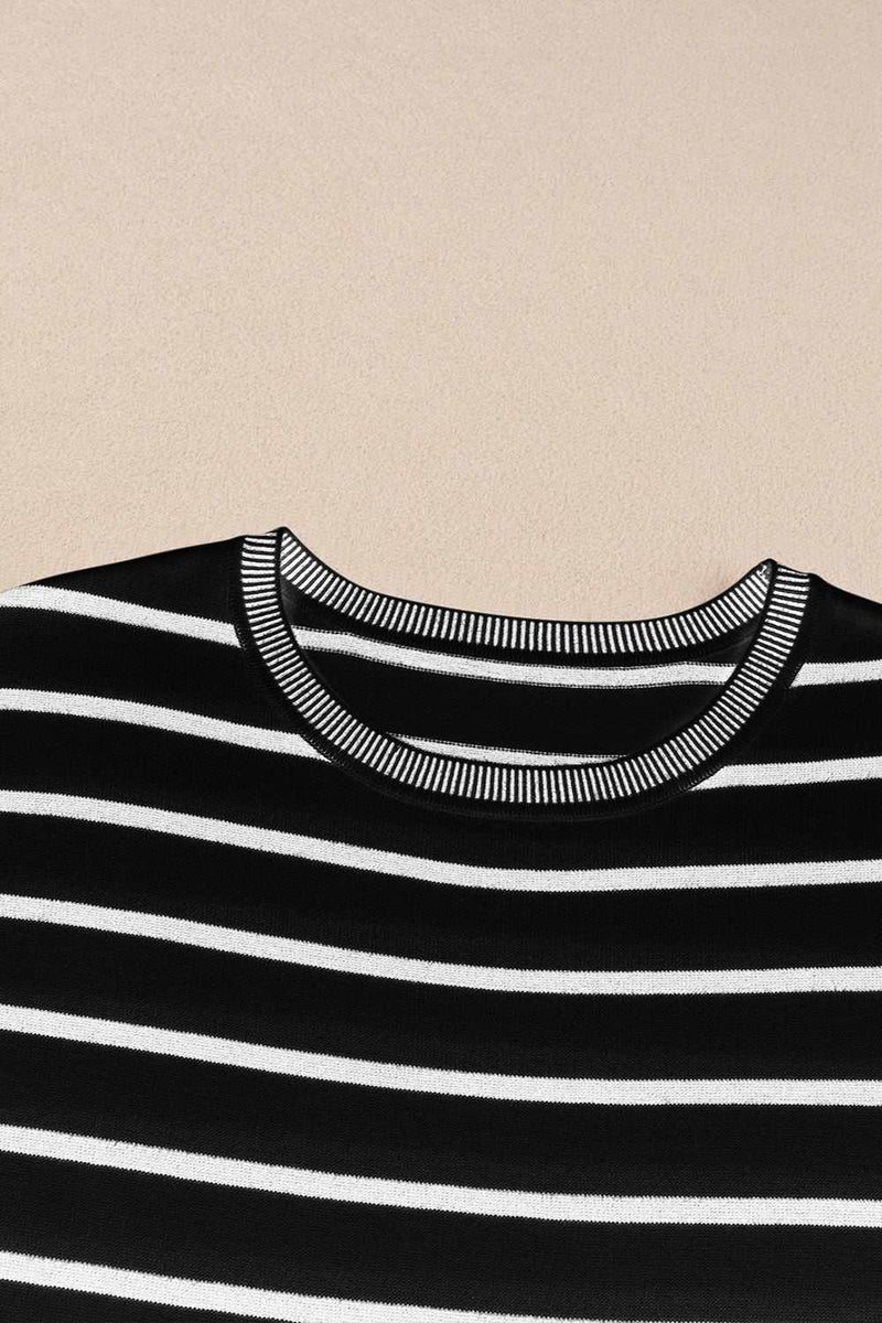 Striped round neck cap sleeve knit top with black and white design.