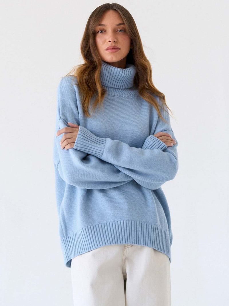 Light blue turtleneck long sleeve sweater made of viscose, polyester, and nylon.