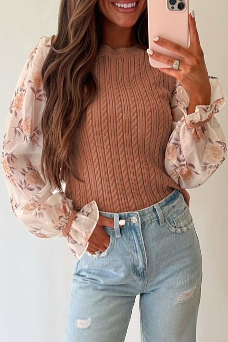 Cable knit round neck sweater with flounce sleeves.
