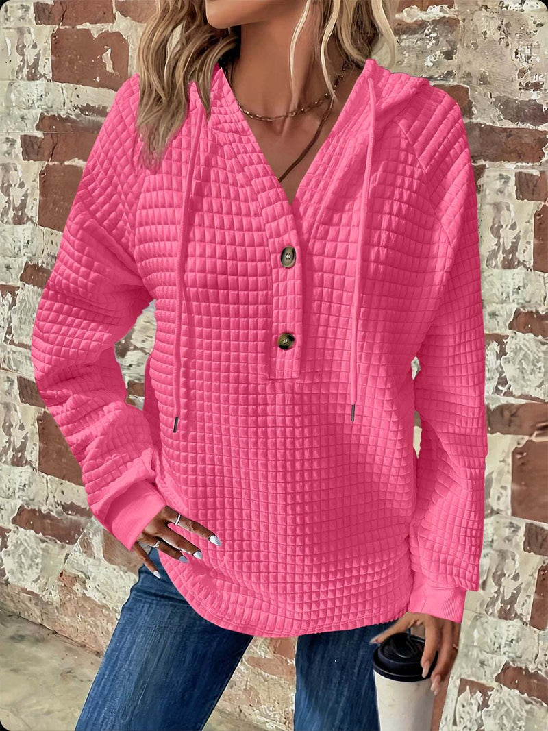 Full size pink textured hoodie with button detail and drawstrings, long sleeves.