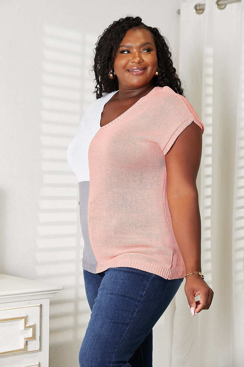 Color block V-neck knit top with short sleeves and ribbed texture.