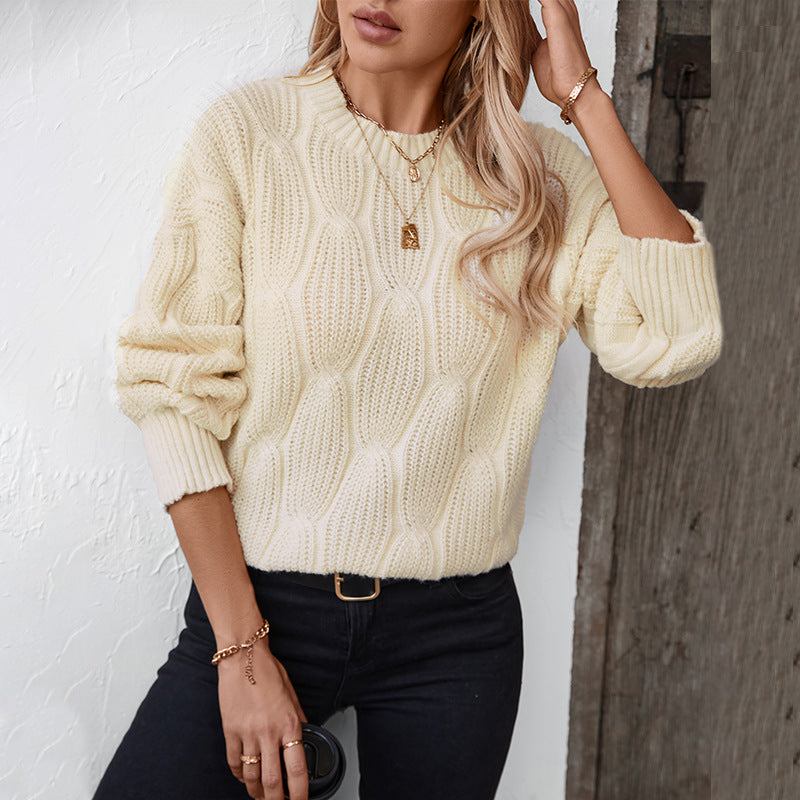 Round neck dropped shoulder sweater in cream, slightly stretchy, 100% polyester.