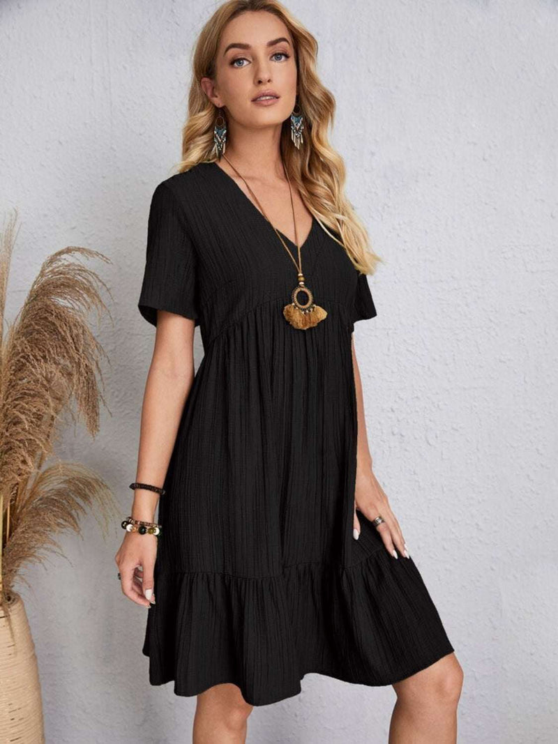 Full size black V-neck short sleeve dress made of 100% polyester.