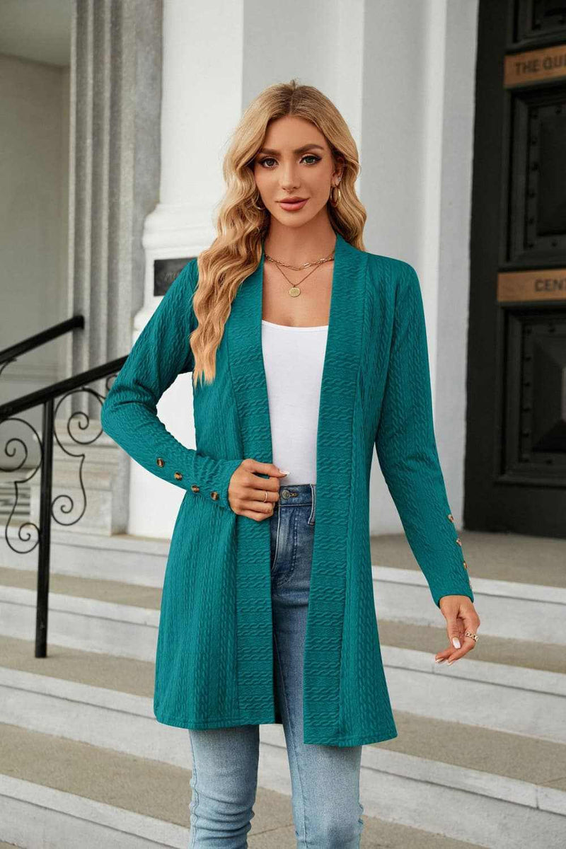 Woman wearing teal long sleeve open front cardigan, casual style with regular sleeves.