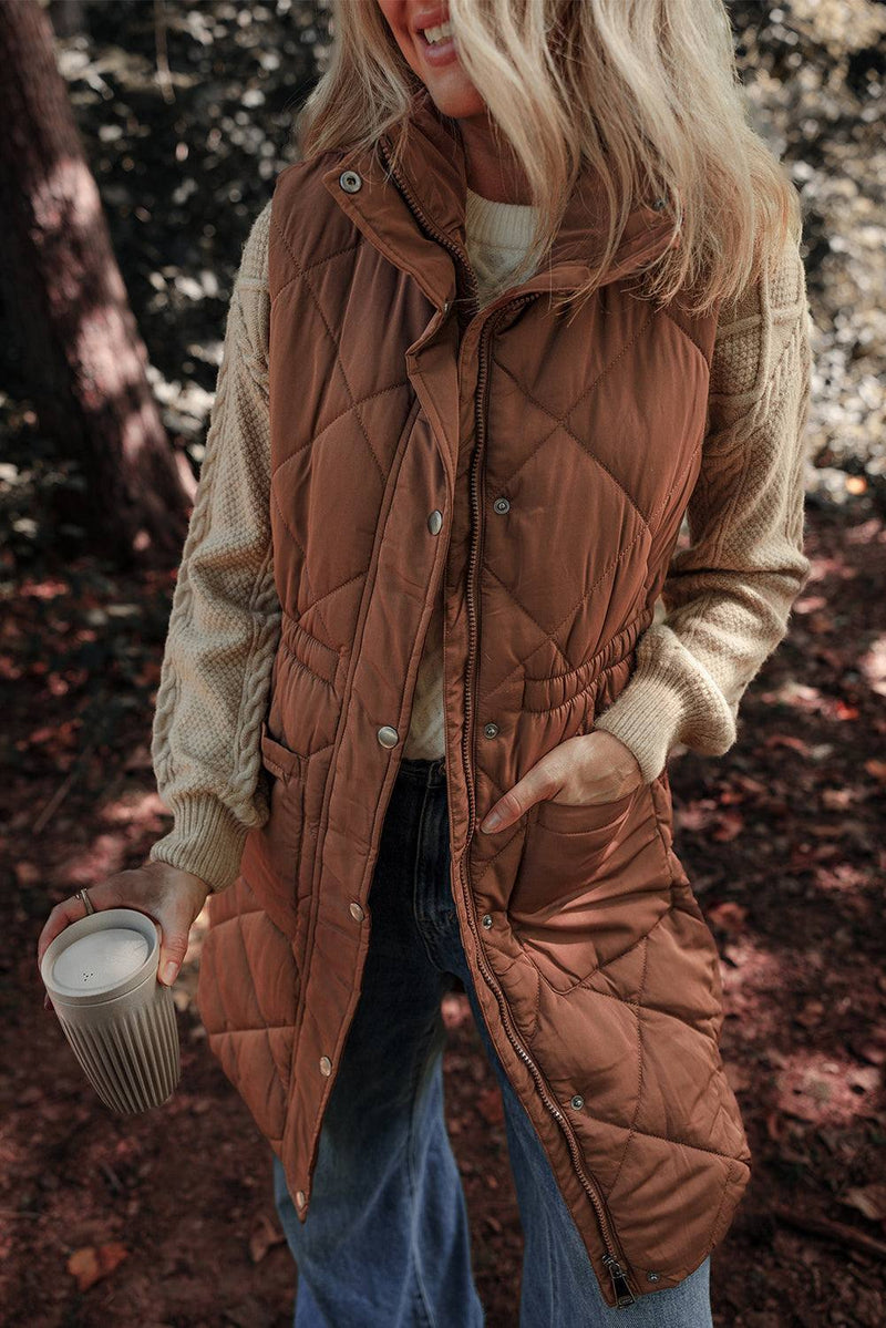 Coffee Longline Quilted Stand Collar Puffer Vest worn outdoors in a forest setting.