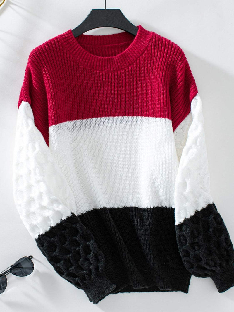 Color block round neck long sleeve sweater with vibrant red, white, and black sections.