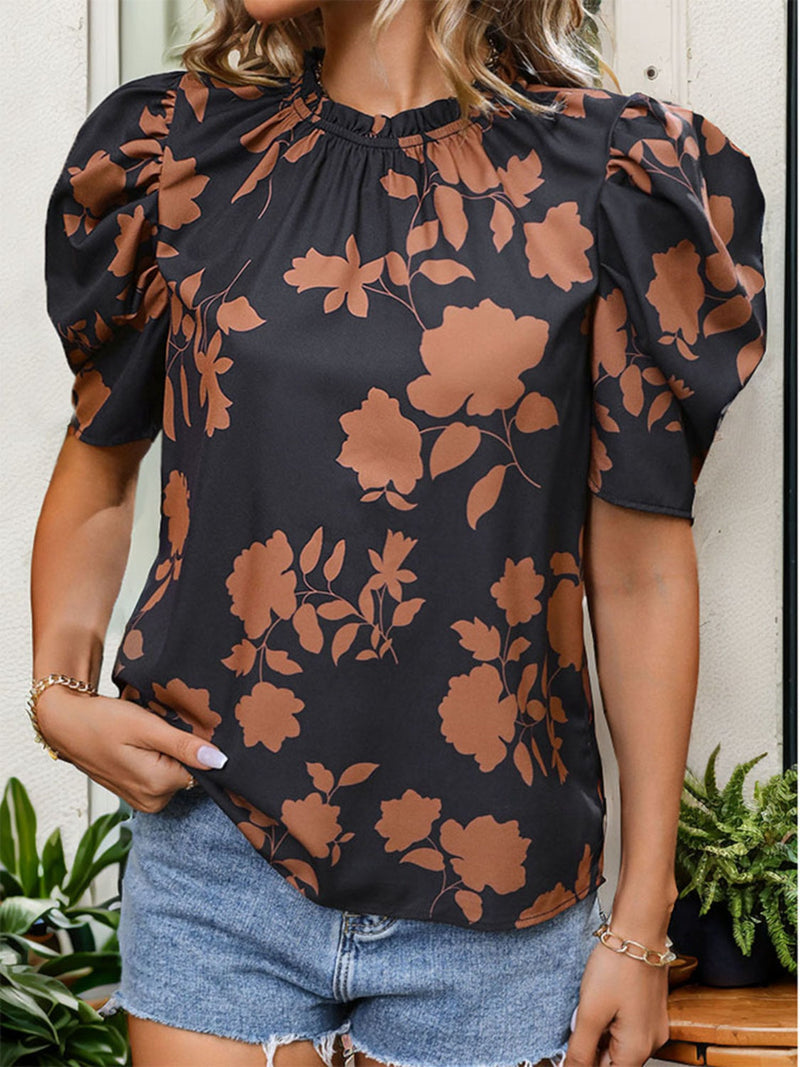 Frill printed round neck puff sleeve blouse with floral design.